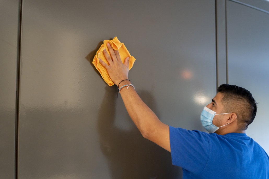 Technician cleaning cigarette smoke nicotine and tar residue on the walls of a home. Cigarette smoke mitigation and cleaning can be completed by American Restoration in Colorado.