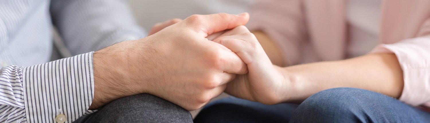 Man and woman holding hands, supporting each other after trauma, American Restoration