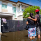 Family looking at flooded water damage house. Residential water damage clean up and mitigation. American Restoration is here to help in an emergency if you're home or commercial building has water damage, flooding, sewage damage in Colorado